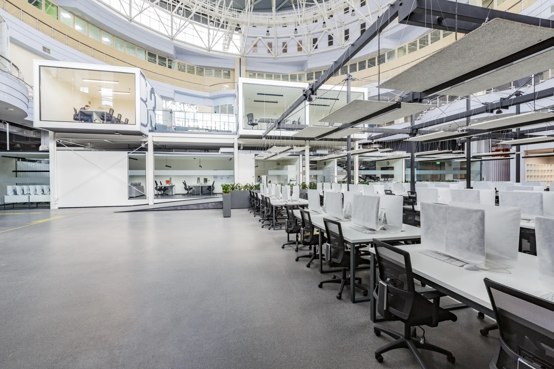An open-plan office with the desks clear and the chairs pushed in